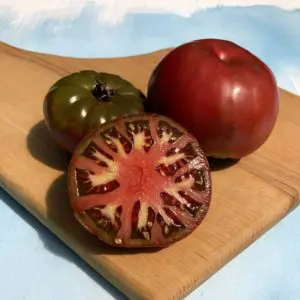 Sliced tomatoes on cutting board.